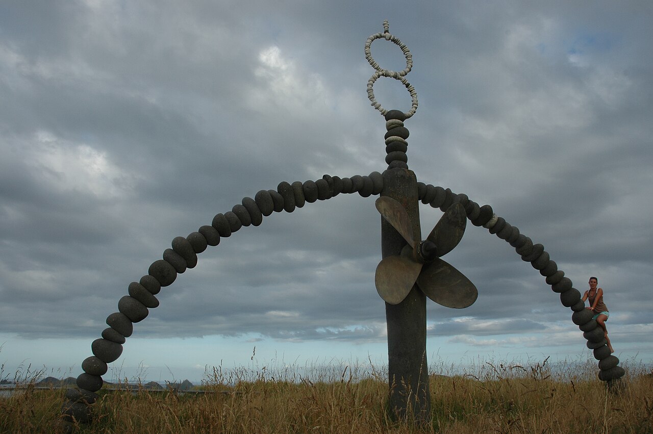 A stone arch surrounding the Rainbow Warrior ship propeller at the memorial above Matauri Bay.
