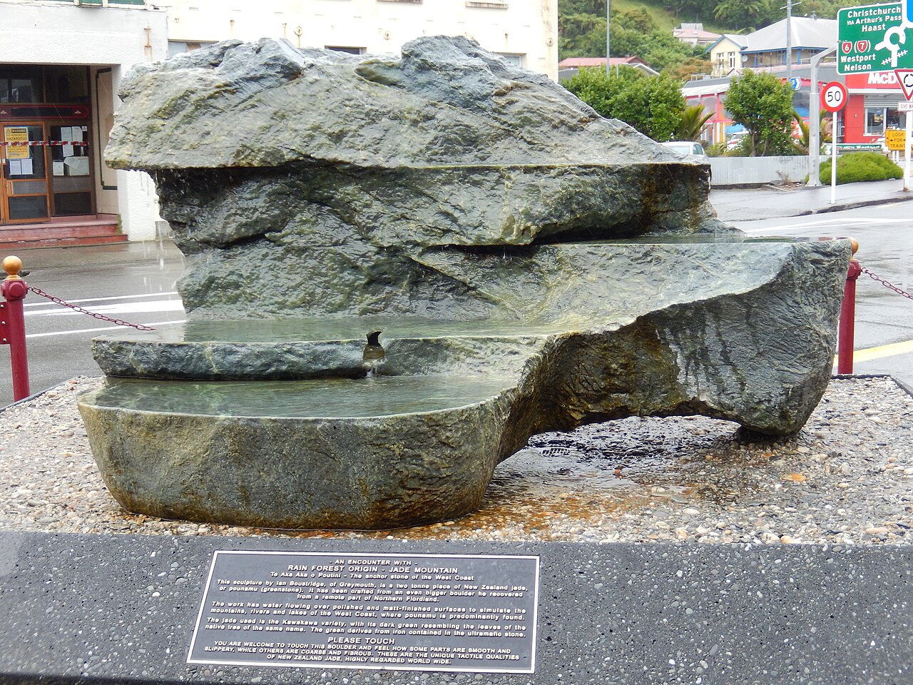 A two-tonne pounamu sculpture carved with stepped pools and running water, on a Greymouth street.