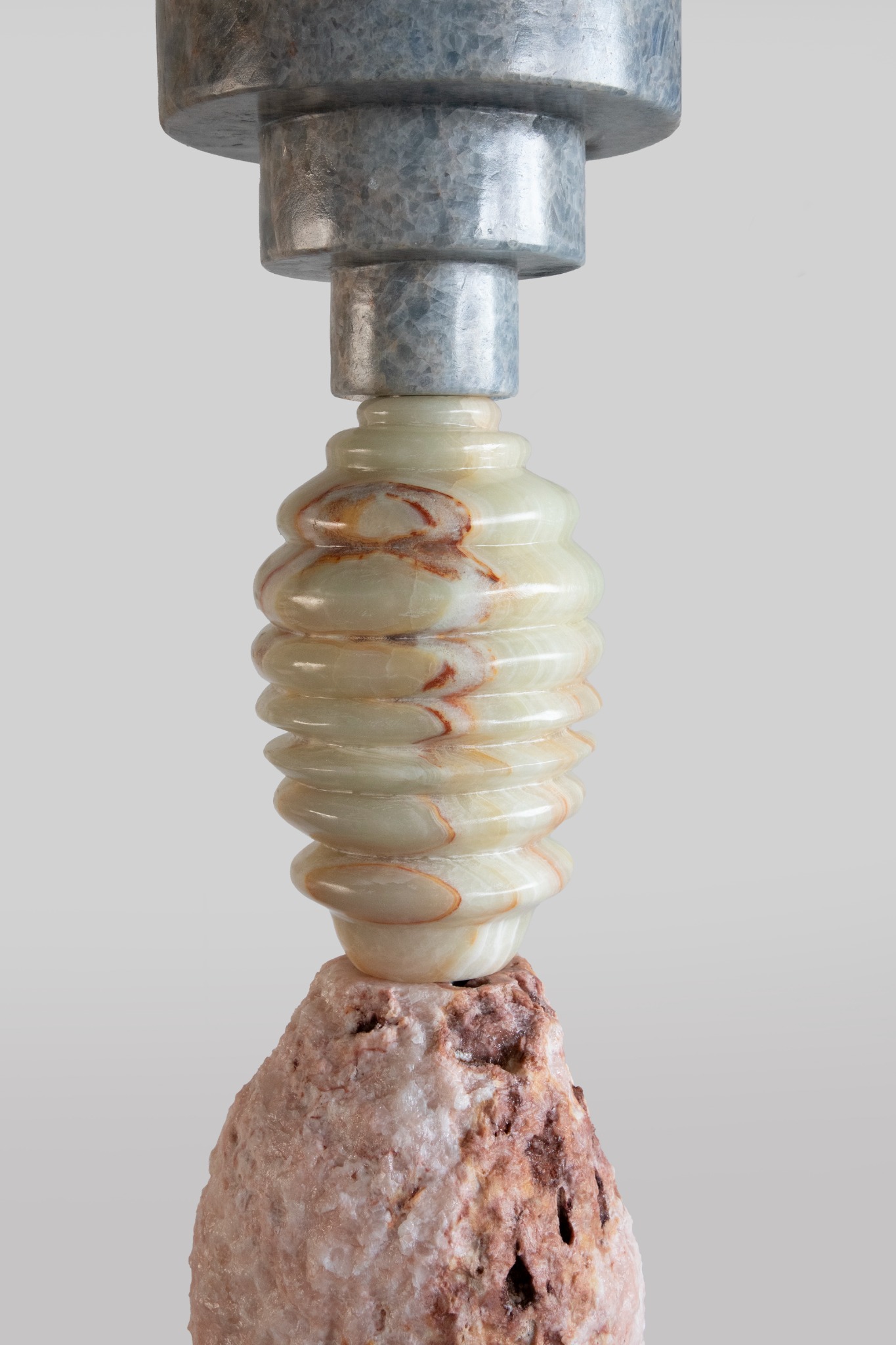 A close view of the polished grey stone and ribbed yellow onyx in Cosmic Relics IV