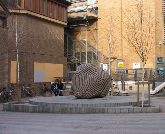 Peter Randall-Page’s granite boulder sculpture Between the Lines, covered in closely spaced carved bands.