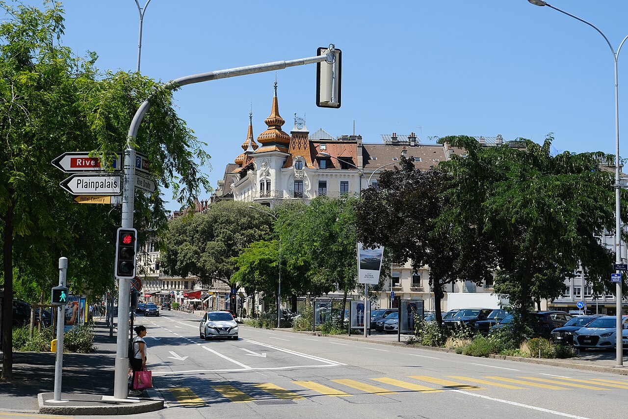 The Maison des Paons in Geneva, showing the restored carved stone facade and its Art Nouveau architectural setting.