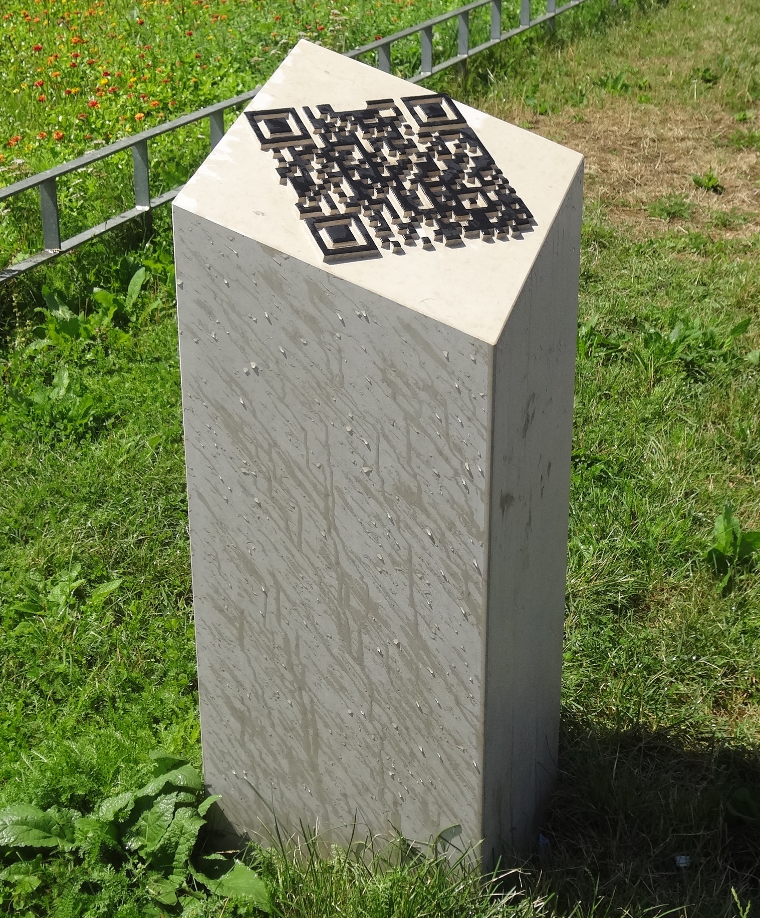 Vincent Du Bois’s Ligne Brisée marble memorial in Geneva, with a carved QR code on its angled top.